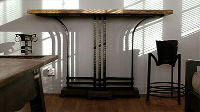 Scene from the video showing the console table made of a wooden surface and cast iron base.