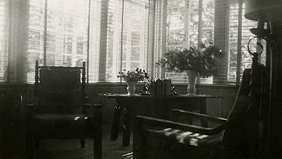 Scene from the video showing the living room with two chairs near the windows.