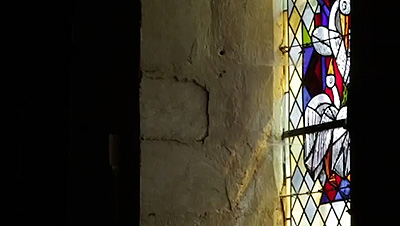 Scene from the video showing a stained glass window inside a romane church, in Lorraine.