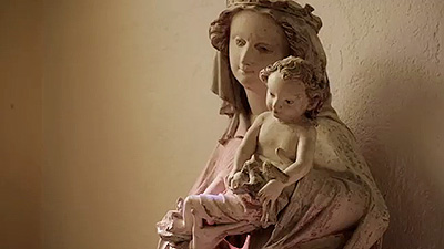 Scene from the video showing a sculpture of Mary holding Baby Jesus.