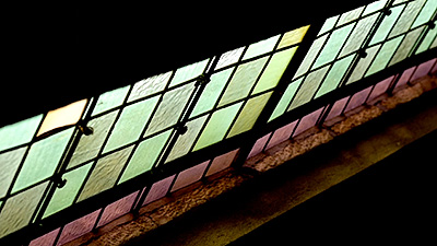 Scene from the video showing a stained-glass window inside a church.