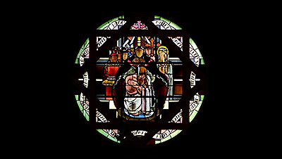 Scene from the video showing a stained-glass window depicting a biblical scene.